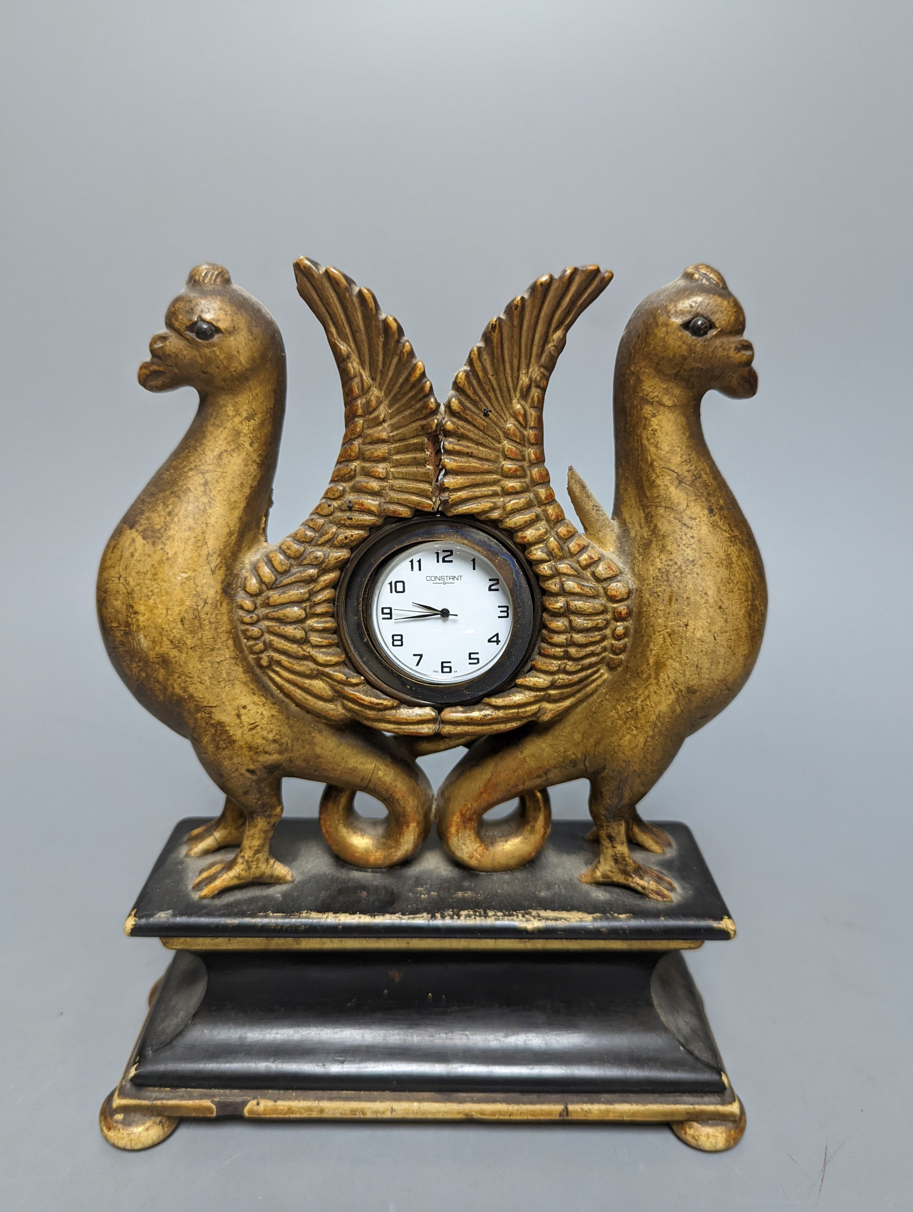 A carved and gilt watch stand, 22 cms high.